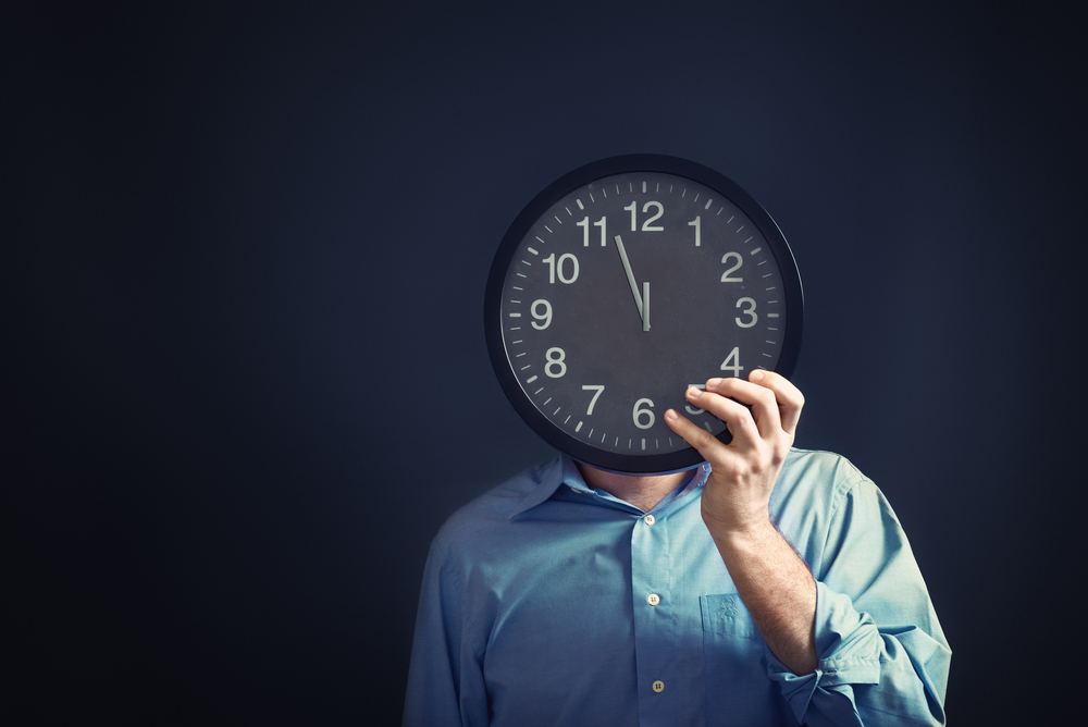 Image of man with clock on head symbolising a lack of time